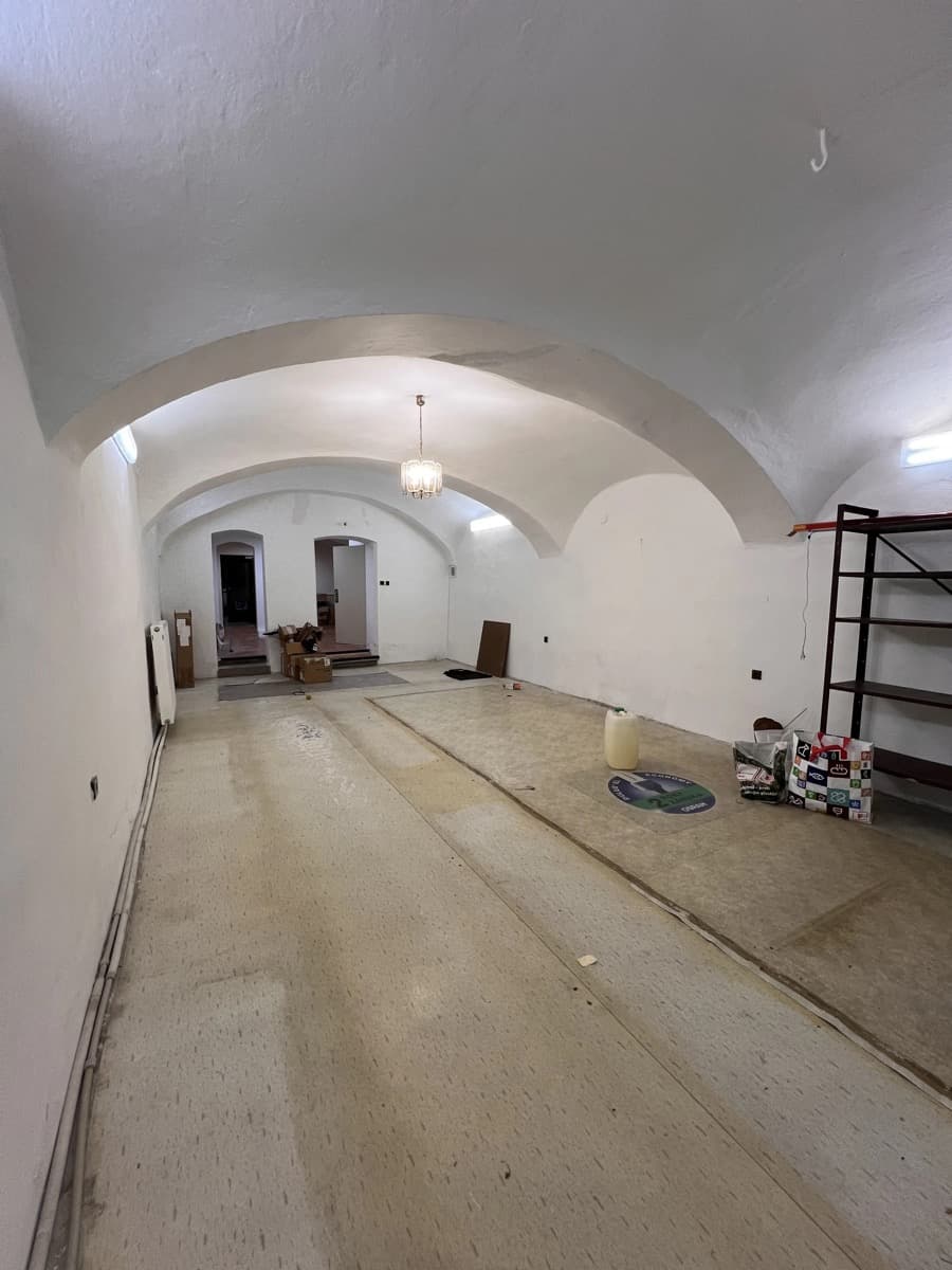 The bare vaulted room before renovation