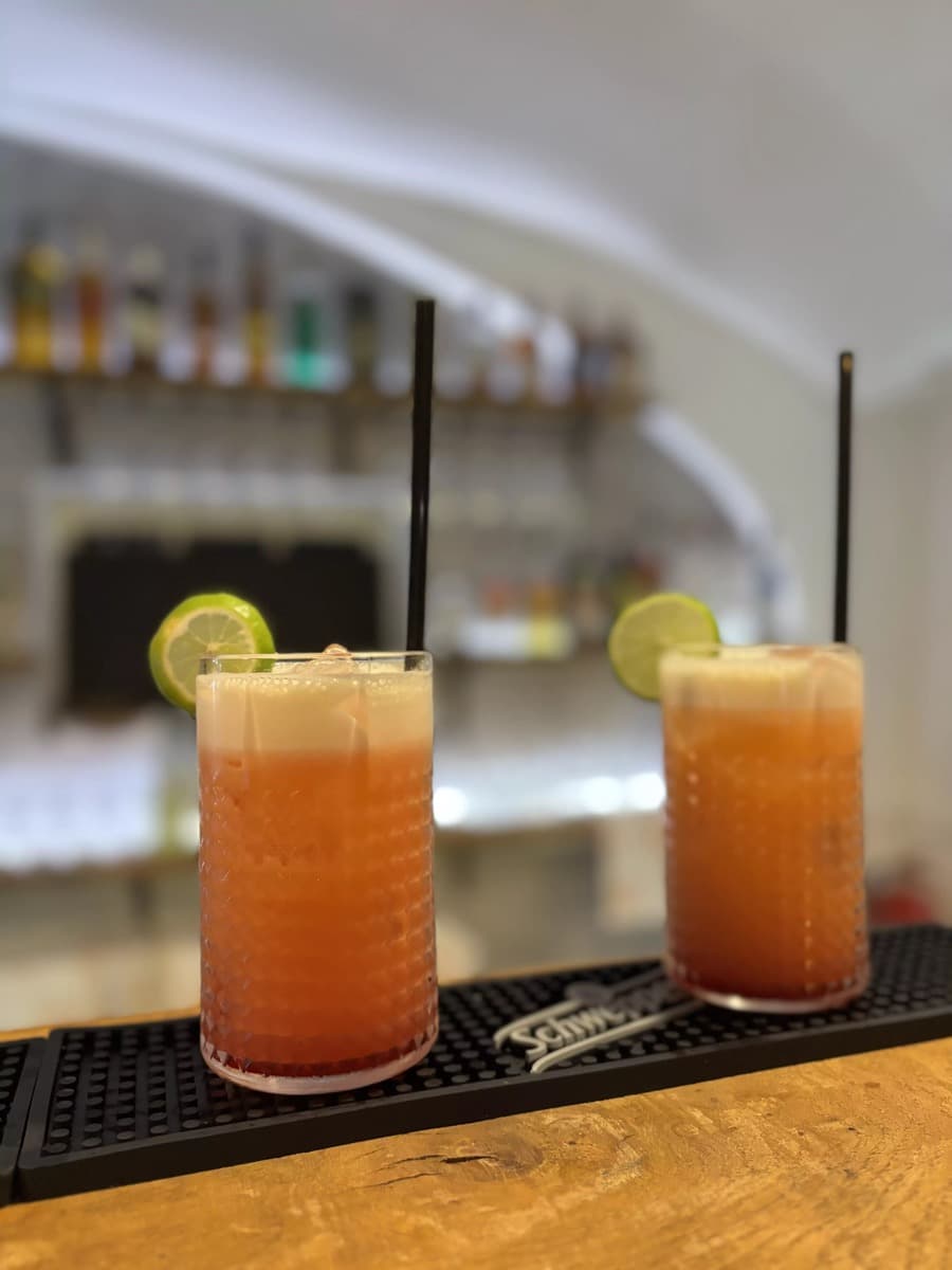 Two cocktails with lime garnish